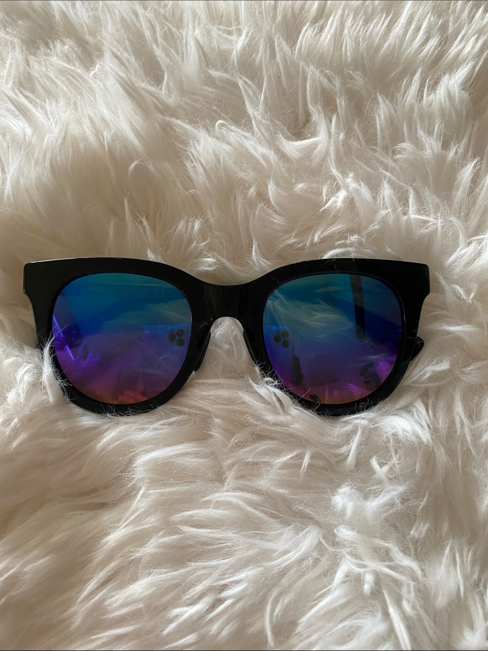 Rebecca Minkoff Black Frame Sunglasses with Blue-Purple Mirrored Lenses.